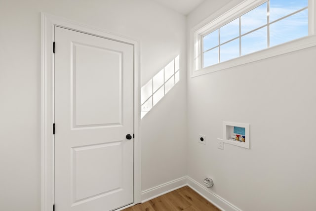 washroom featuring hookup for a washing machine, electric dryer hookup, and light hardwood / wood-style flooring