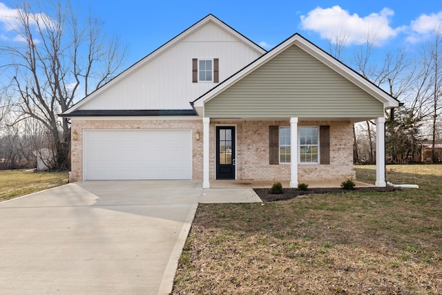 view of front of property with a porch, a garage, and a front yard