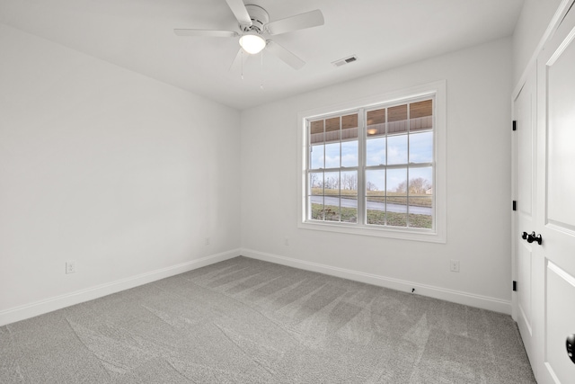 empty room with ceiling fan and carpet flooring