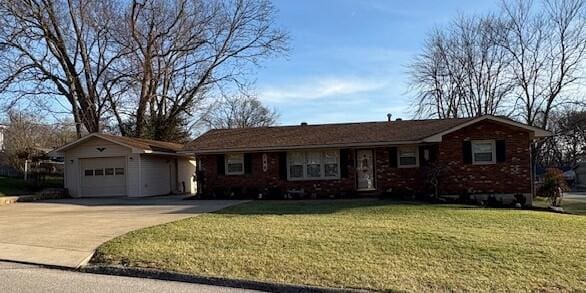 ranch-style house with a garage and a front lawn