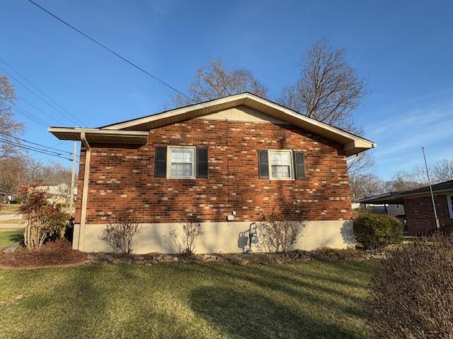 view of side of home featuring a yard