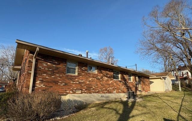 view of property exterior with a lawn and central air condition unit