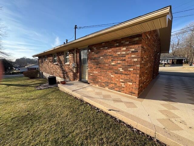 view of side of home featuring a lawn