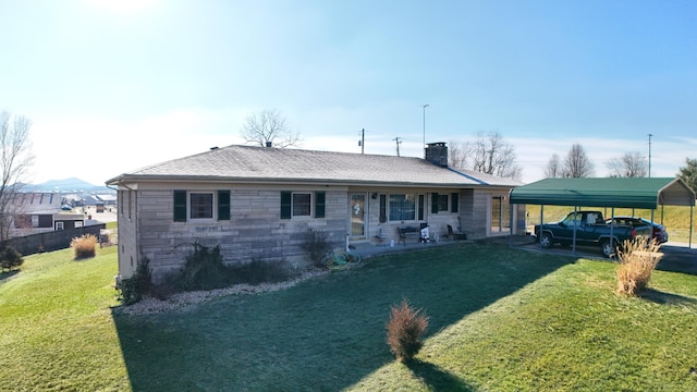 back of property with a carport, cooling unit, and a lawn