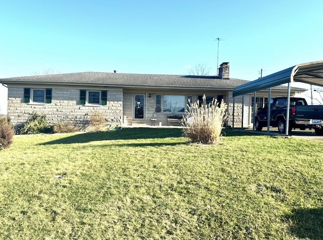 back of house featuring a carport and a lawn