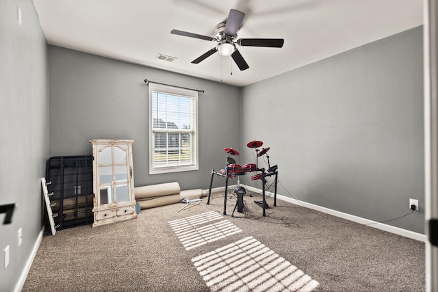 living area with ceiling fan and carpet