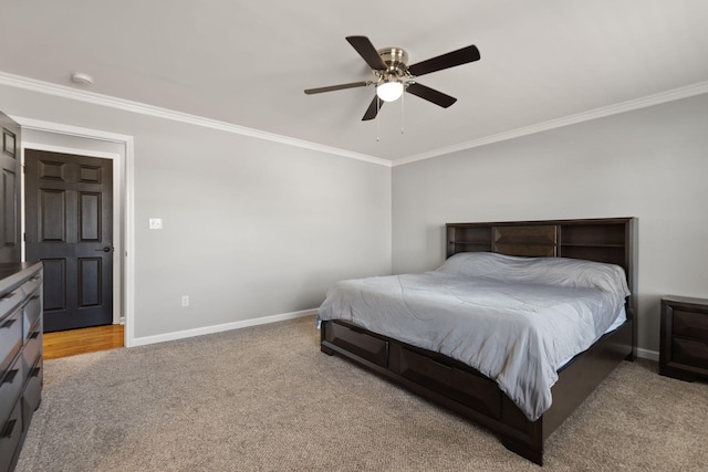 carpeted bedroom with ornamental molding and ceiling fan