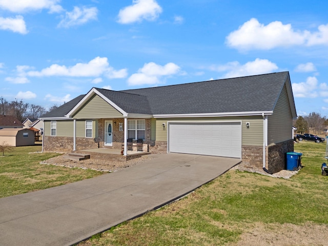 view of front of house featuring a garage, covered porch, and a front lawn