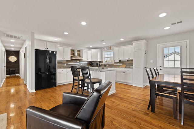 living room featuring sink and light hardwood / wood-style floors