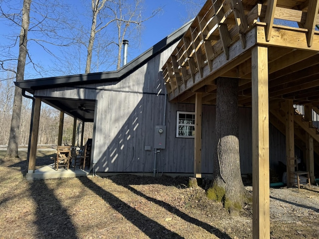 view of side of home with a patio and ceiling fan