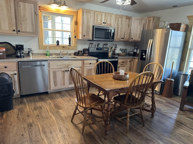 kitchen featuring sink, dark hardwood / wood-style flooring, ceiling fan, appliances with stainless steel finishes, and light brown cabinetry