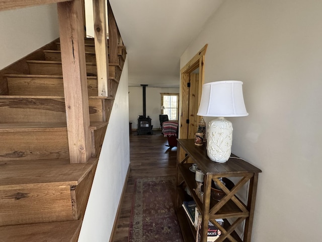 stairway featuring hardwood / wood-style flooring and a wood stove