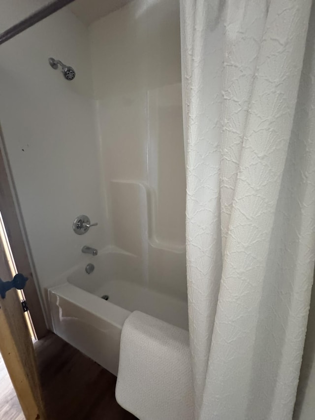 bathroom featuring shower / tub combo and hardwood / wood-style flooring