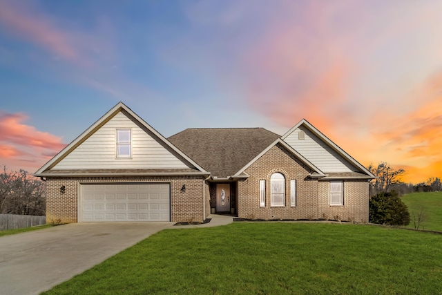 view of front of property with a garage and a lawn