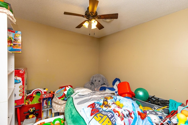 bedroom featuring a ceiling fan and a textured ceiling