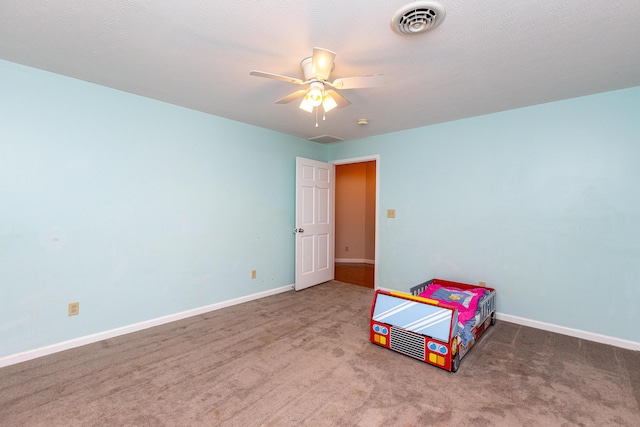 unfurnished bedroom with carpet, visible vents, ceiling fan, and baseboards