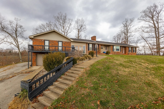 ranch-style house featuring brick siding, a chimney, an attached garage, driveway, and a front lawn