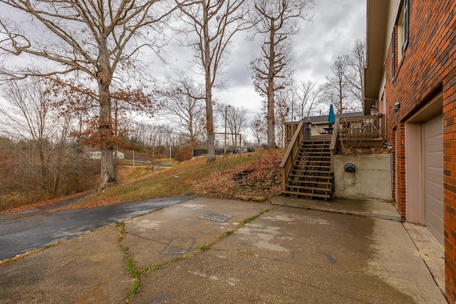 view of yard featuring stairs, a patio, and a wooden deck