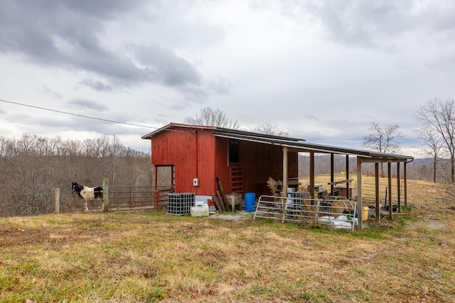 view of outdoor structure featuring an outdoor structure, an exterior structure, and central air condition unit