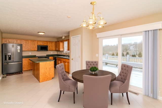 dining area featuring a chandelier and visible vents