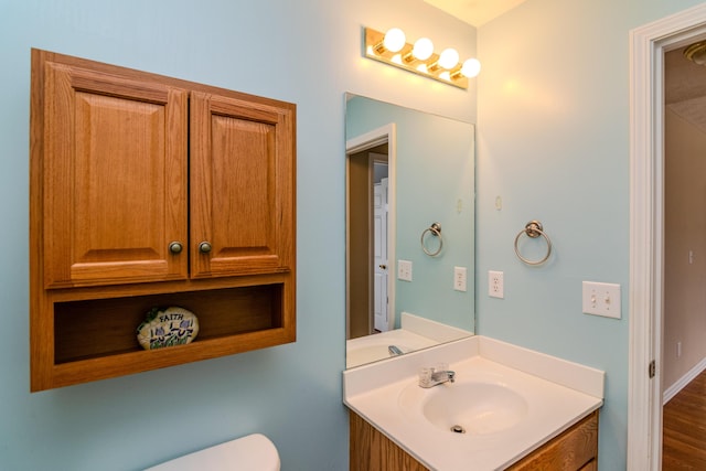 bathroom featuring toilet and vanity