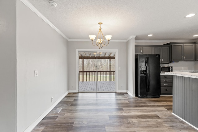 kitchen featuring wood-type flooring, a chandelier, black fridge with ice dispenser, crown molding, and a textured ceiling