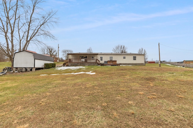 exterior space with a wooden deck, a yard, and a storage shed