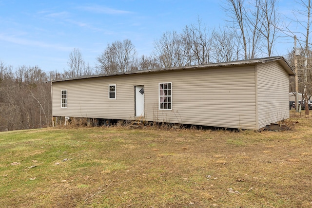 back of house with a lawn