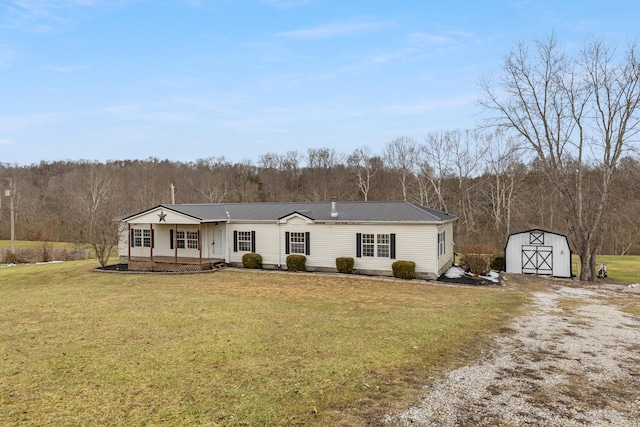 view of front of home featuring covered porch, a front lawn, and a storage unit