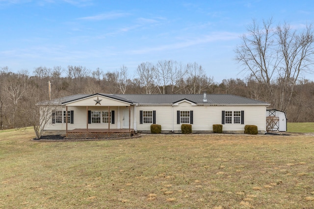 view of front of property with a front yard, covered porch, and a storage unit