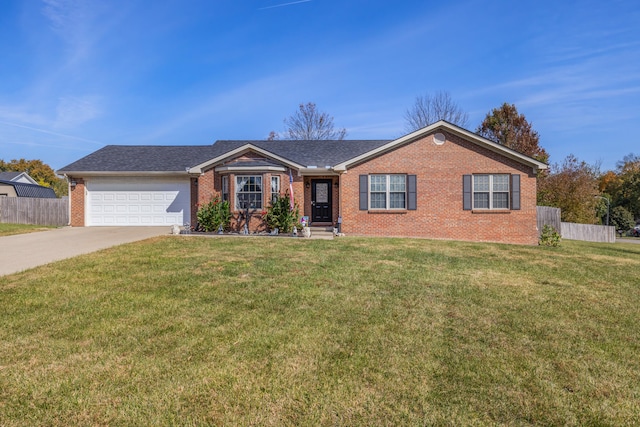 ranch-style house featuring a garage and a front lawn