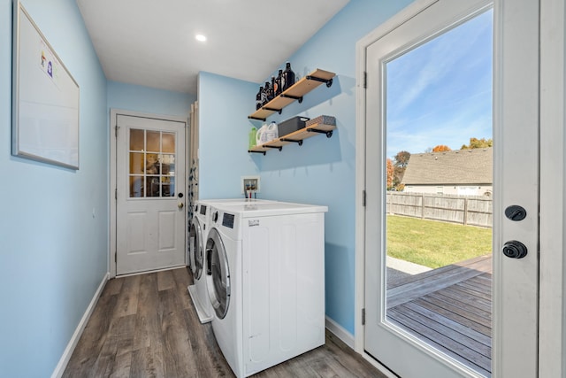 washroom with dark hardwood / wood-style floors and washer and clothes dryer