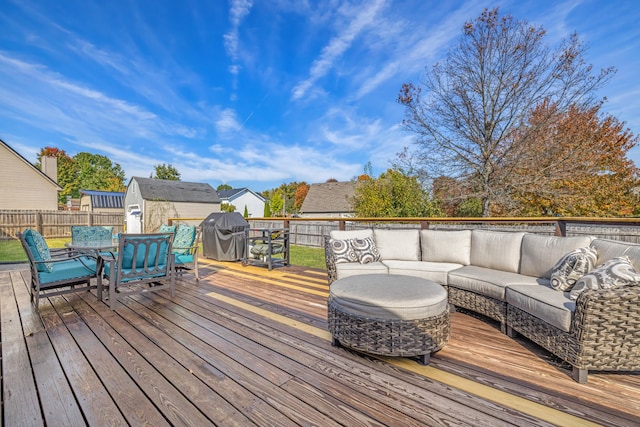 deck featuring area for grilling, an outdoor hangout area, and a storage unit