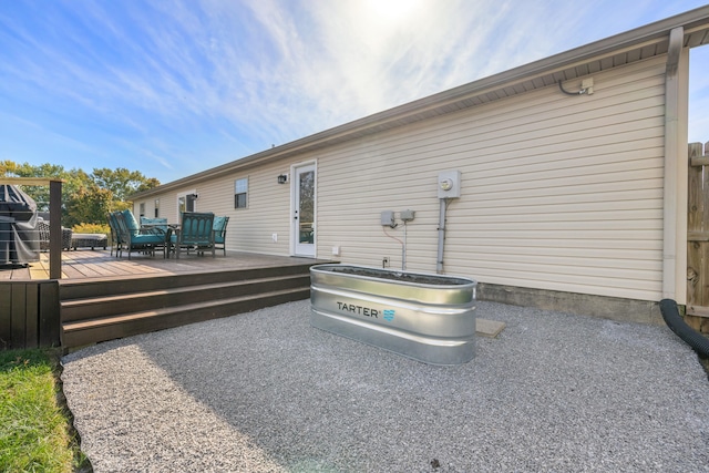 back of property with a wooden deck