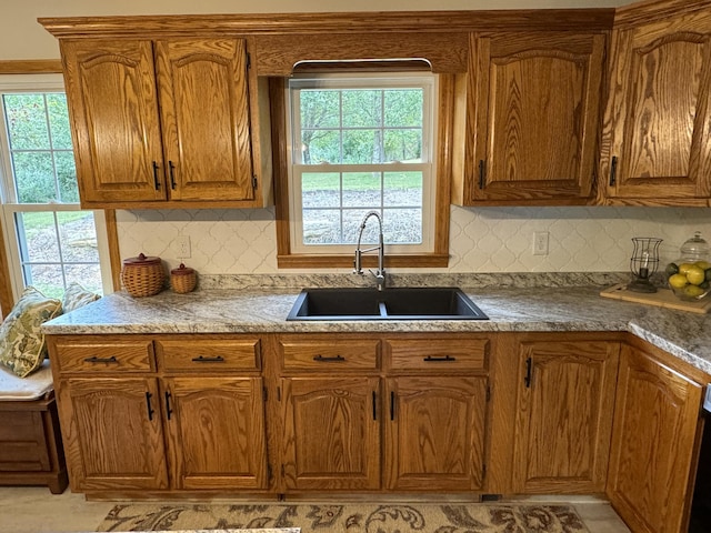 kitchen featuring a healthy amount of sunlight, sink, and decorative backsplash