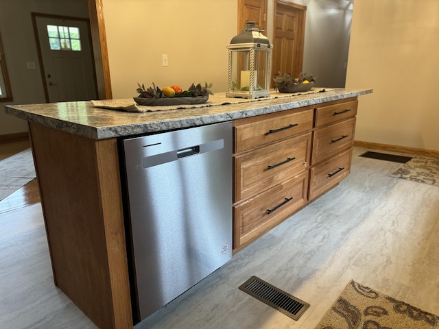 kitchen with light wood-type flooring, dishwasher, and a kitchen island