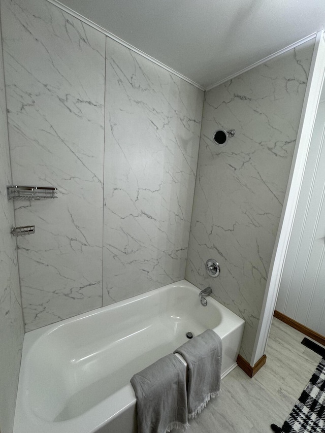 bathroom featuring hardwood / wood-style flooring and tiled shower / bath combo