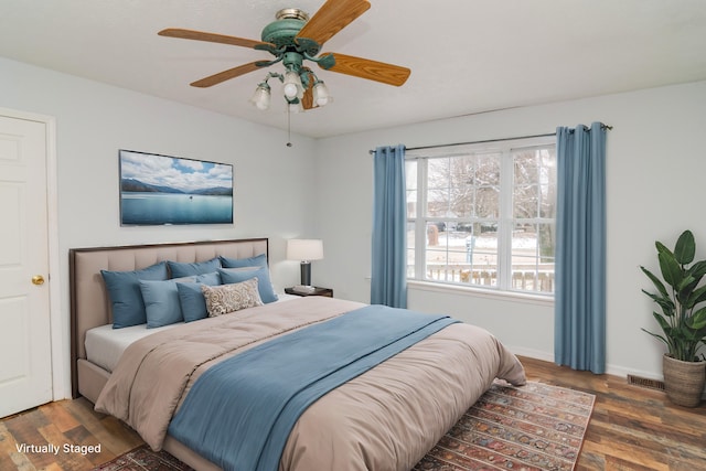 bedroom featuring dark wood-style flooring, visible vents, ceiling fan, and baseboards