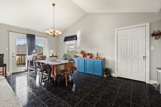 dining space with a chandelier, vaulted ceiling, and dark tile patterned flooring