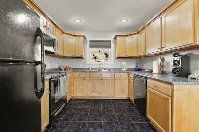 kitchen featuring light brown cabinetry, sink, a textured ceiling, dark tile patterned floors, and black appliances