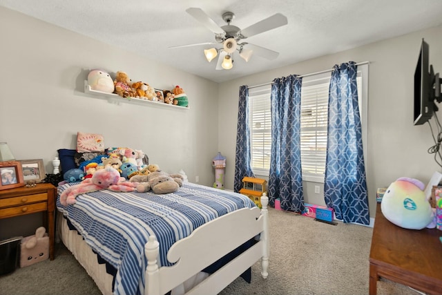 carpeted bedroom featuring a textured ceiling and ceiling fan