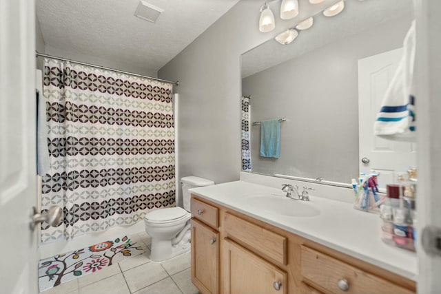 bathroom featuring tile patterned floors, toilet, vanity, and a textured ceiling