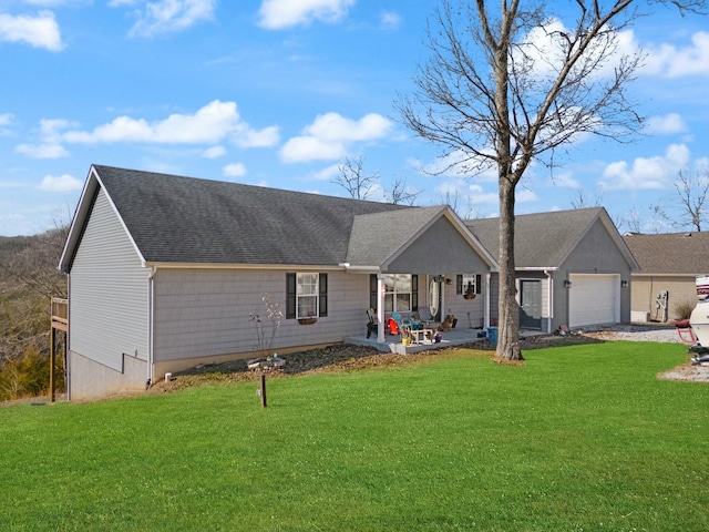 single story home with a garage and a front lawn