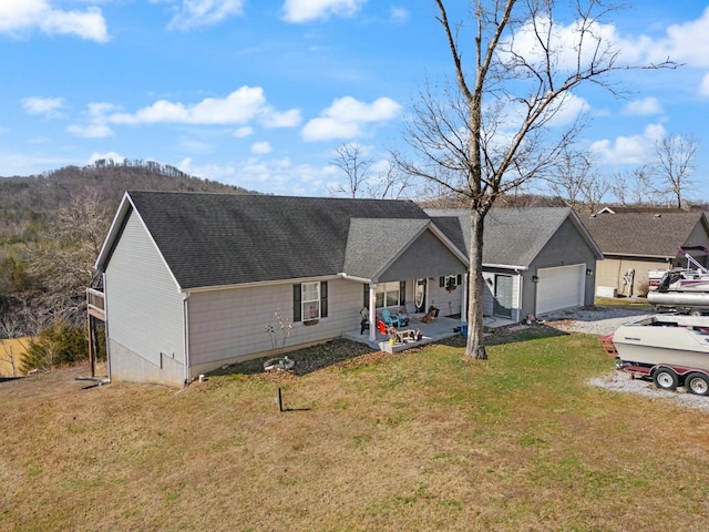 single story home featuring a garage and a front yard