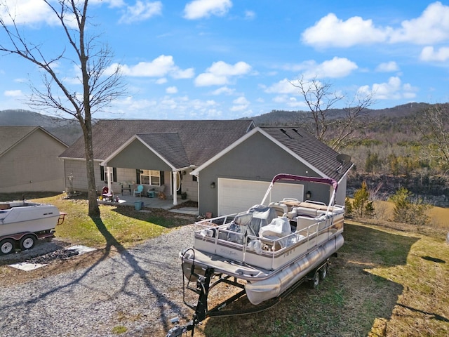 ranch-style home with a garage and a front lawn