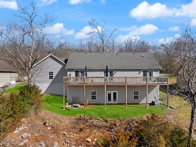 rear view of house featuring a yard, cooling unit, a deck, and french doors