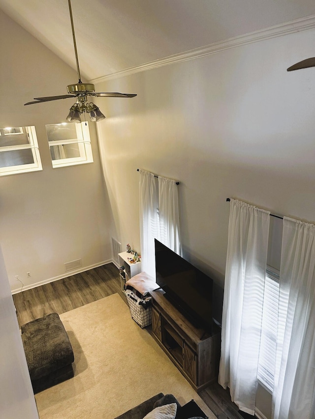 unfurnished living room with vaulted ceiling, ceiling fan, ornamental molding, and hardwood / wood-style floors