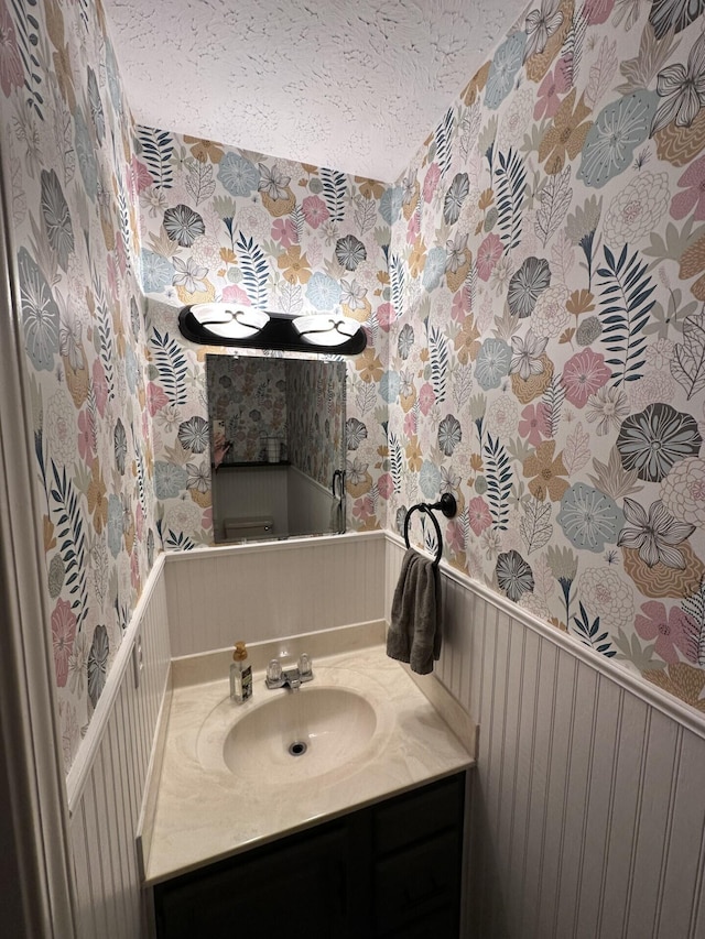 bathroom with vanity and a textured ceiling