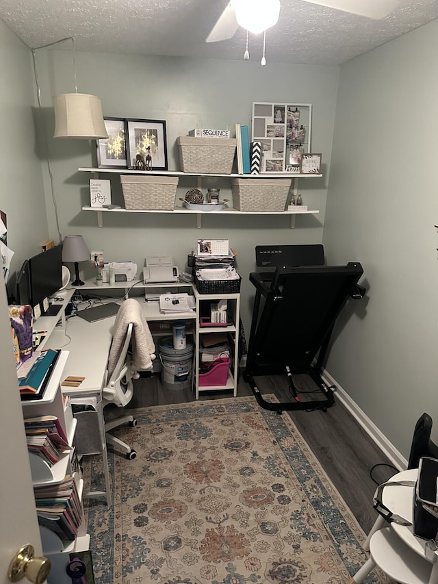 office area featuring hardwood / wood-style floors, a textured ceiling, and ceiling fan