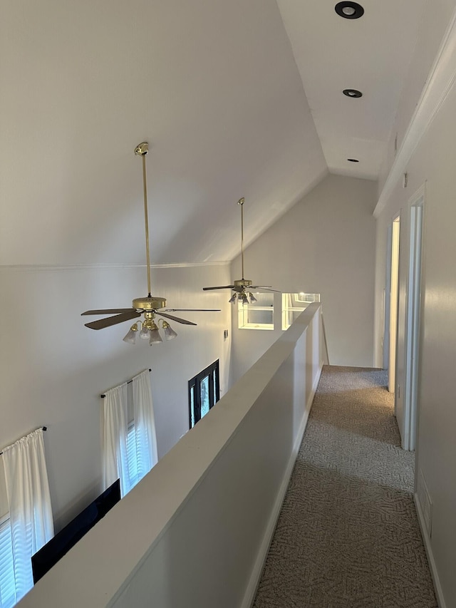 corridor featuring lofted ceiling and carpet flooring